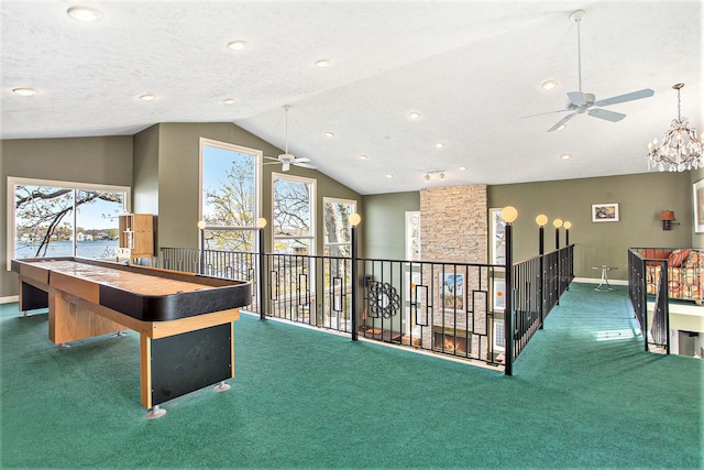 playroom featuring vaulted ceiling, carpet, and ceiling fan with notable chandelier