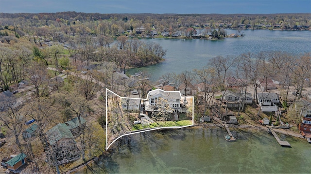 drone / aerial view featuring a water view and a forest view