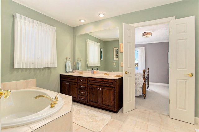 ensuite bathroom featuring tile patterned flooring, double vanity, a bath, a sink, and ensuite bath