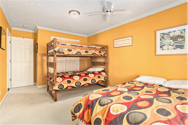 carpeted bedroom with crown molding, baseboards, ceiling fan, and a textured ceiling