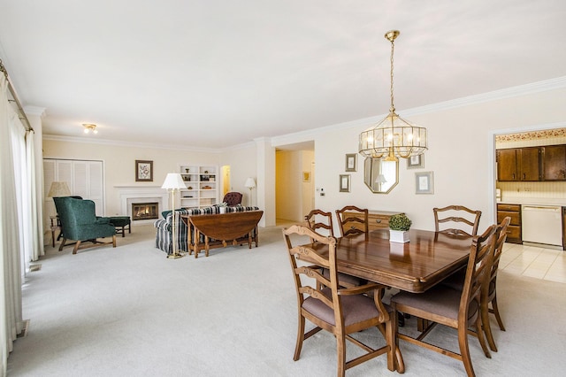 dining area featuring crown molding, an inviting chandelier, light carpet, and a glass covered fireplace