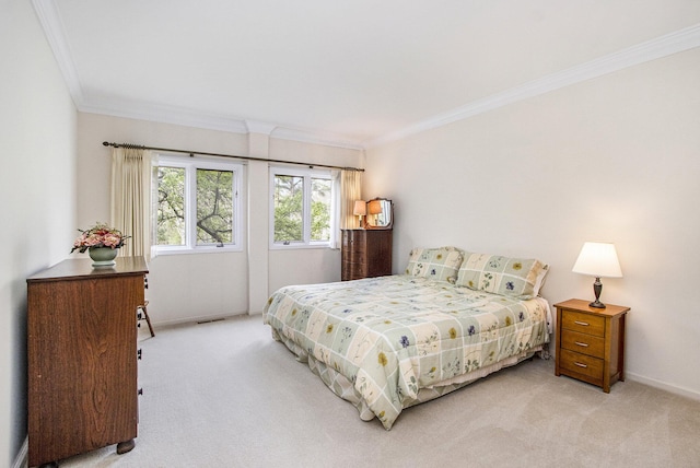 bedroom featuring baseboards, ornamental molding, and light carpet