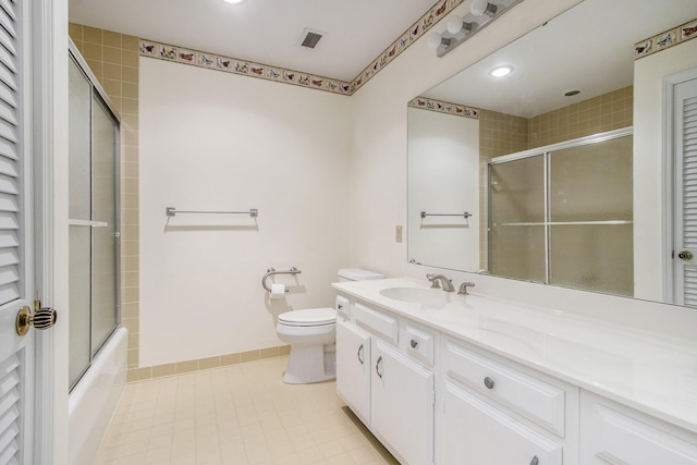 full bath with toilet, tile patterned floors, shower / bath combination with glass door, and vanity
