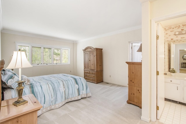 bedroom featuring crown molding, light carpet, and ensuite bathroom