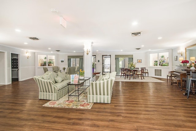 living room with visible vents, recessed lighting, and wood finished floors