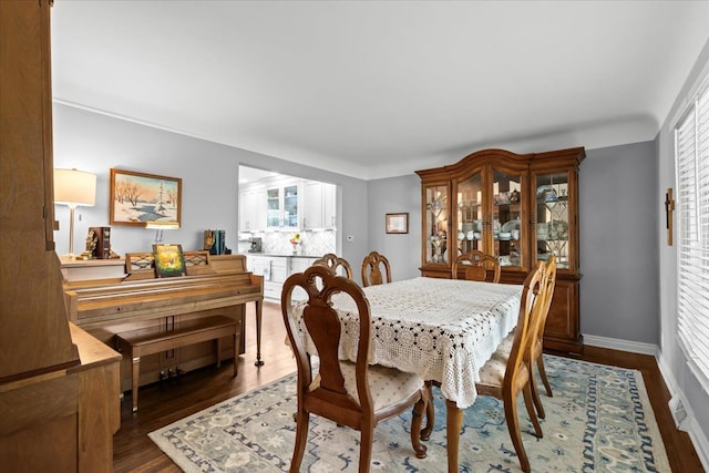 dining space featuring baseboards, dark wood finished floors, and a healthy amount of sunlight