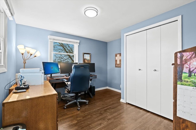 office area featuring dark wood-style flooring and baseboards