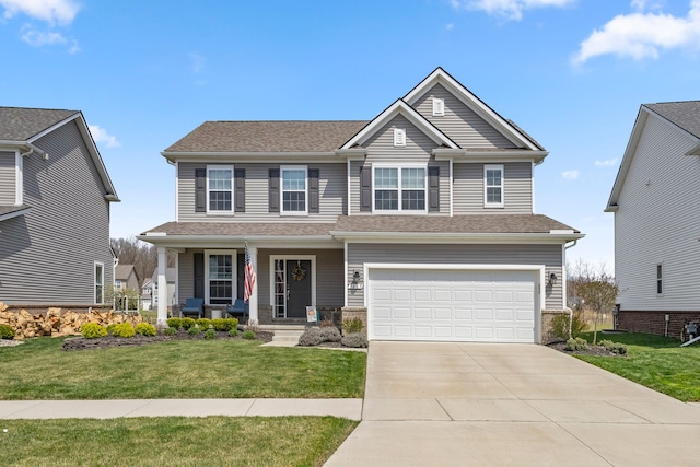 craftsman-style home with an attached garage, concrete driveway, a porch, and a front lawn