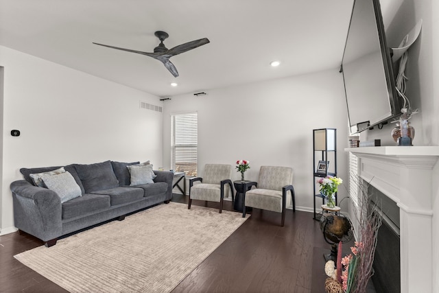 living area featuring ceiling fan, recessed lighting, dark wood-style floors, and visible vents