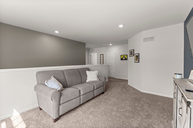 living area with visible vents, recessed lighting, baseboards, and light carpet