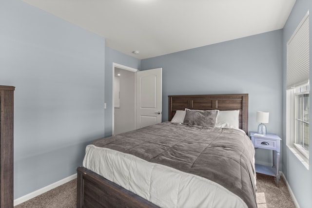 carpeted bedroom with baseboards and multiple windows