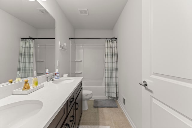 bathroom featuring a sink, tile patterned floors, double vanity, and visible vents