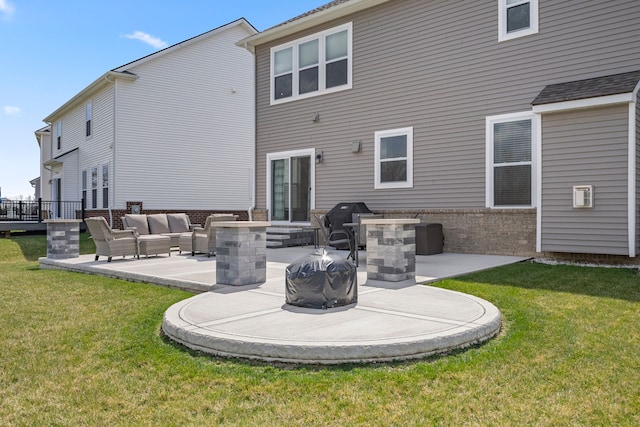 rear view of property with a lawn, an outdoor living space, a patio area, and brick siding
