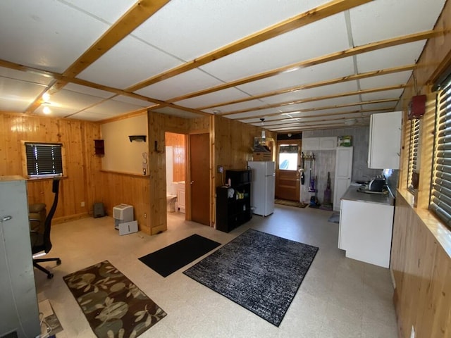 interior space with light floors and wooden walls