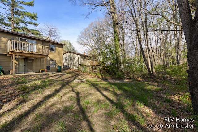 view of yard with a wooden deck and a fenced backyard