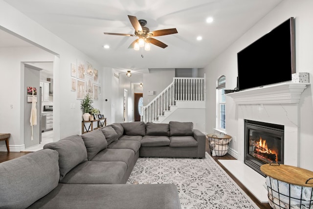 7891 Robindale Ave, Dearborn Heights, MI 48127 - living area featuring stairway, recessed lighting, a ceiling fan, a premium fireplace, and wood finished floors