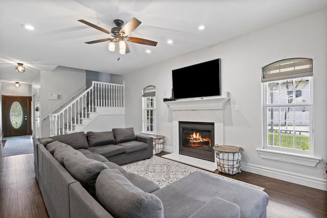 7891 Robindale Ave, Dearborn Heights, MI 48127 - living room with stairs, baseboards, a fireplace, a ceiling fan, and wood finished floors