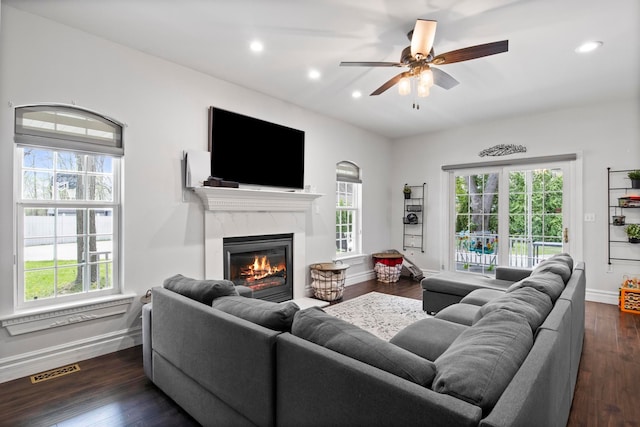 7891 Robindale Ave, Dearborn Heights, MI 48127 - living area featuring baseboards, plenty of natural light, recessed lighting, a high end fireplace, and dark wood-style flooring