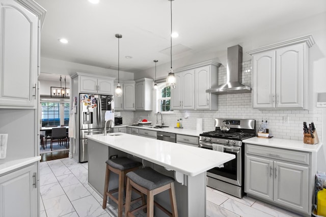 7891 Robindale Ave, Dearborn Heights, MI 48127 - kitchen with stainless steel appliances, wall chimney exhaust hood, light marble finish floors, gray cabinetry, and recessed lighting