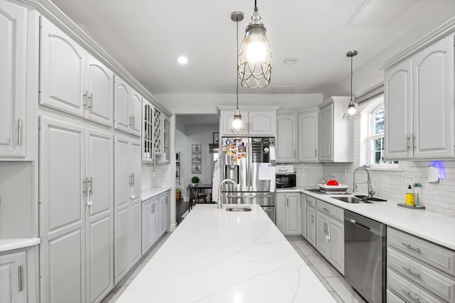 7891 Robindale Ave, Dearborn Heights, MI 48127 - kitchen with appliances with stainless steel finishes, a sink, tasteful backsplash, glass insert cabinets, and pendant lighting
