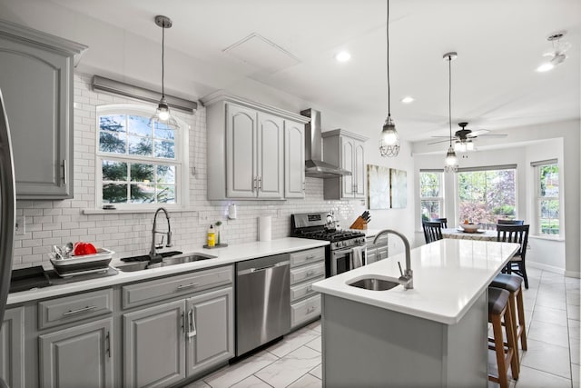 7891 Robindale Ave, Dearborn Heights, MI 48127 - kitchen with a sink, appliances with stainless steel finishes, gray cabinets, wall chimney exhaust hood, and recessed lighting