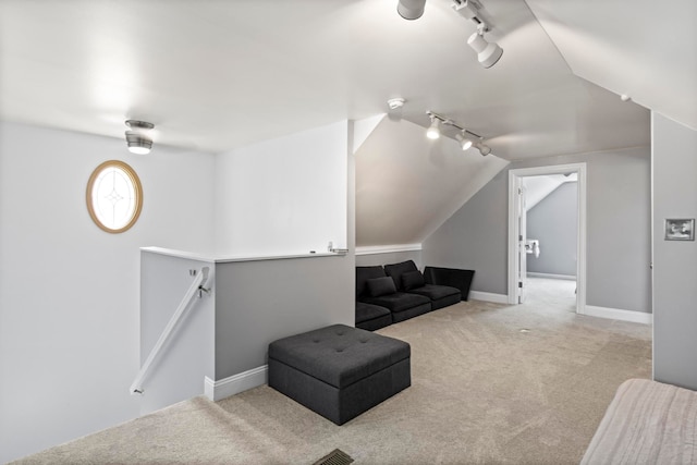 7891 Robindale Ave, Dearborn Heights, MI 48127 - living area featuring rail lighting, carpet flooring, lofted ceiling, baseboards, and an upstairs landing