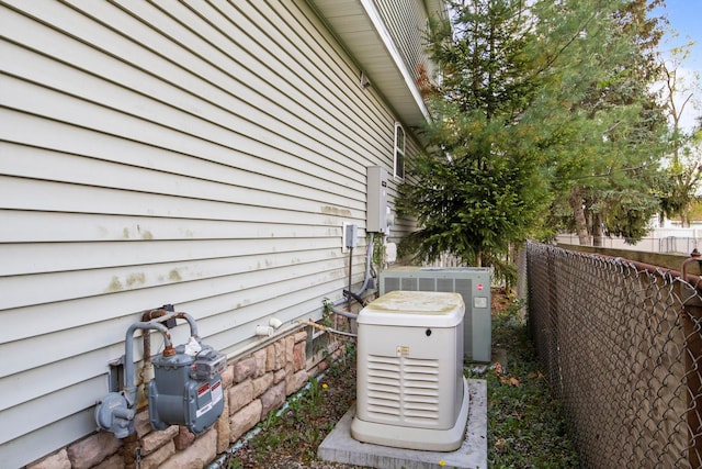 7891 Robindale Ave, Dearborn Heights, MI 48127 - exterior view of a power unit, central AC, fence, and gas meter