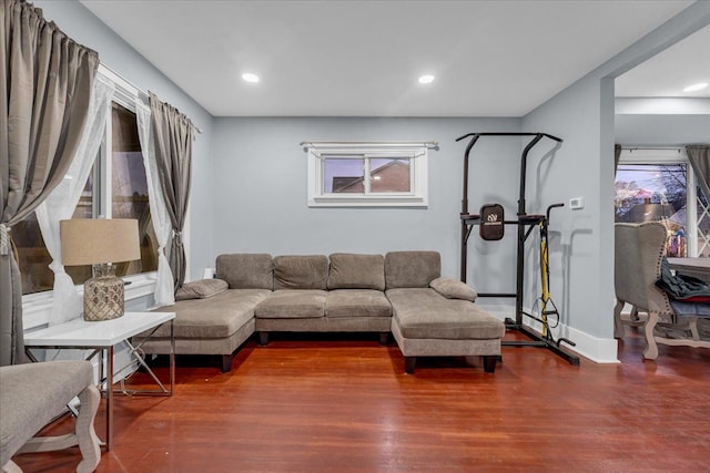 living area with recessed lighting, baseboards, and wood finished floors