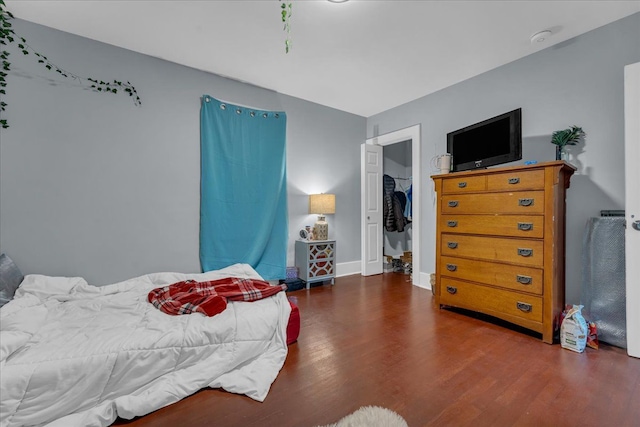 bedroom with baseboards and wood finished floors