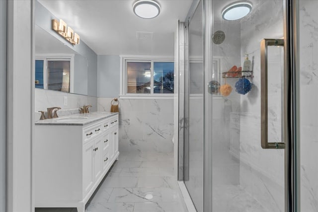 full bath with vanity, a marble finish shower, marble finish floor, tile walls, and visible vents
