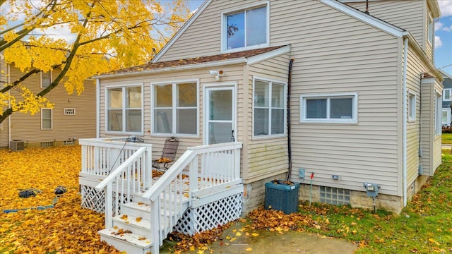 rear view of house featuring central air condition unit and a deck
