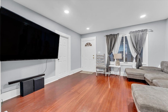 living room with recessed lighting, baseboards, and wood finished floors