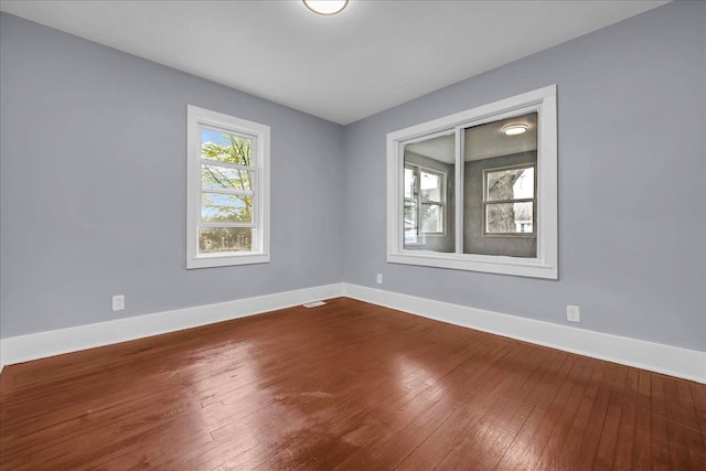 3690 Phillips Ave, Berkley, MI 48072 - spare room featuring baseboards, dark wood finished floors, and visible vents