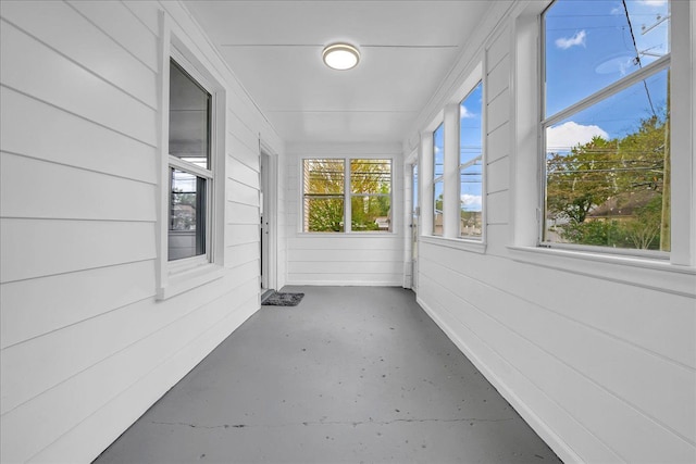 3690 Phillips Ave, Berkley, MI 48072 - unfurnished sunroom with wood walls and concrete flooring