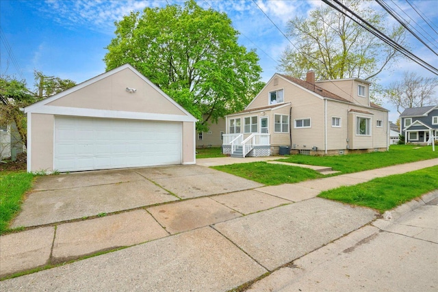 3690 Phillips Ave, Berkley, MI 48072 - view of front of property featuring central AC, a front lawn, a detached garage, a chimney, and an outdoor structure