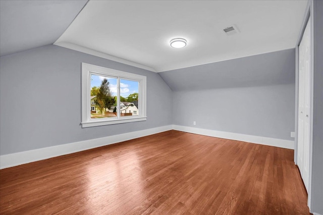 3690 Phillips Ave, Berkley, MI 48072 - additional living space with baseboards, vaulted ceiling, wood finished floors, and visible vents