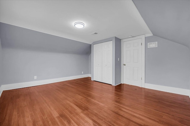 3690 Phillips Ave, Berkley, MI 48072 - additional living space featuring baseboards, vaulted ceiling, wood finished floors, and visible vents
