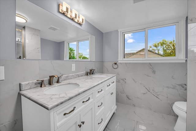 3690 Phillips Ave, Berkley, MI 48072 - full bath with double vanity, a sink, marble finish floor, and tile walls