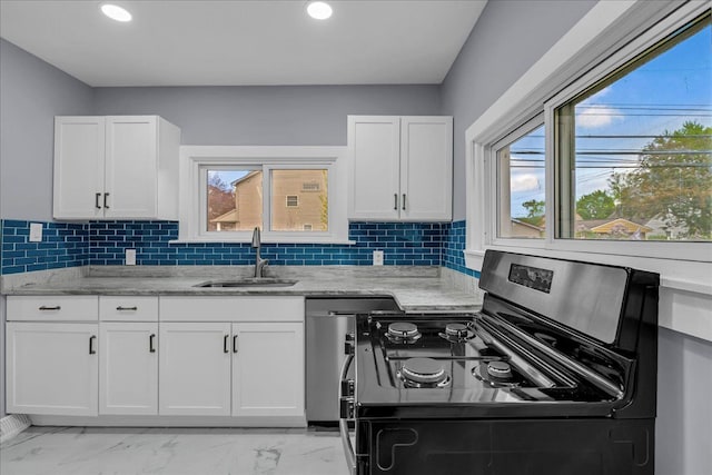 3690 Phillips Ave, Berkley, MI 48072 - kitchen with stainless steel range with gas stovetop, white cabinets, light stone countertops, and a sink
