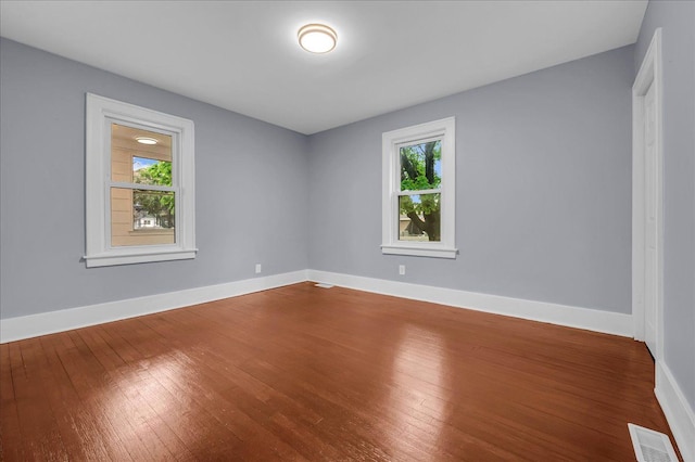 3690 Phillips Ave, Berkley, MI 48072 - unfurnished room with plenty of natural light, baseboards, visible vents, and hardwood / wood-style flooring