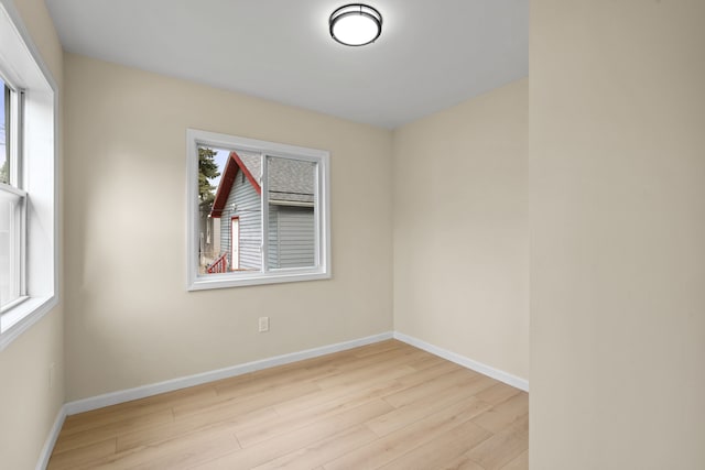 empty room featuring baseboards and wood finished floors