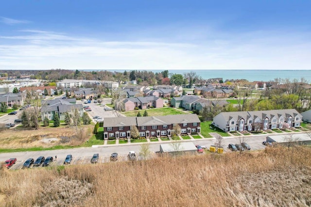 birds eye view of property with a residential view and a water view