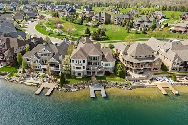 birds eye view of property with a water view and a residential view