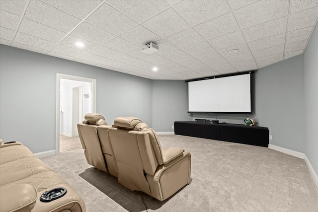 carpeted home theater room with a paneled ceiling, baseboards, and recessed lighting