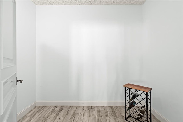 unfurnished room with baseboards and wood finished floors