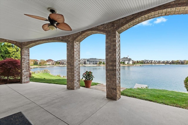 view of patio / terrace with a water view, a residential view, and ceiling fan