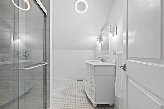 bathroom featuring a shower stall, baseboards, tile patterned floors, and vanity