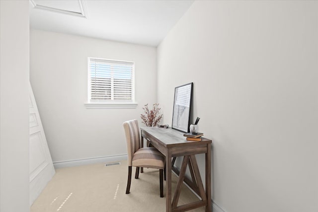 office space with baseboards, attic access, visible vents, and light colored carpet