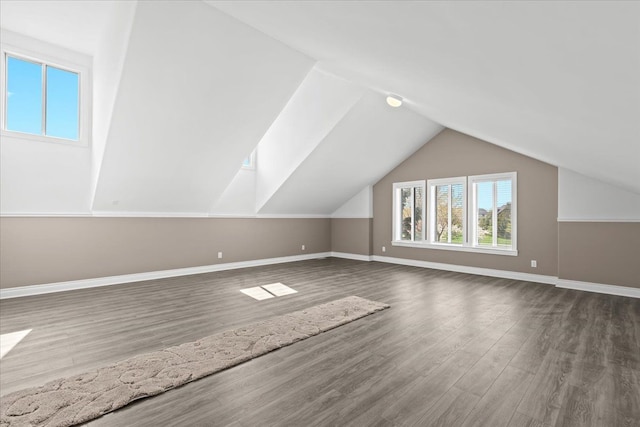 bonus room featuring wood finished floors, baseboards, and lofted ceiling