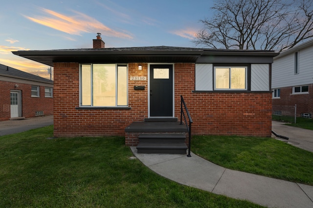 23130 Beverly St, Saint Clair Shores, MI 48082 - bungalow with brick siding, a lawn, and a chimney